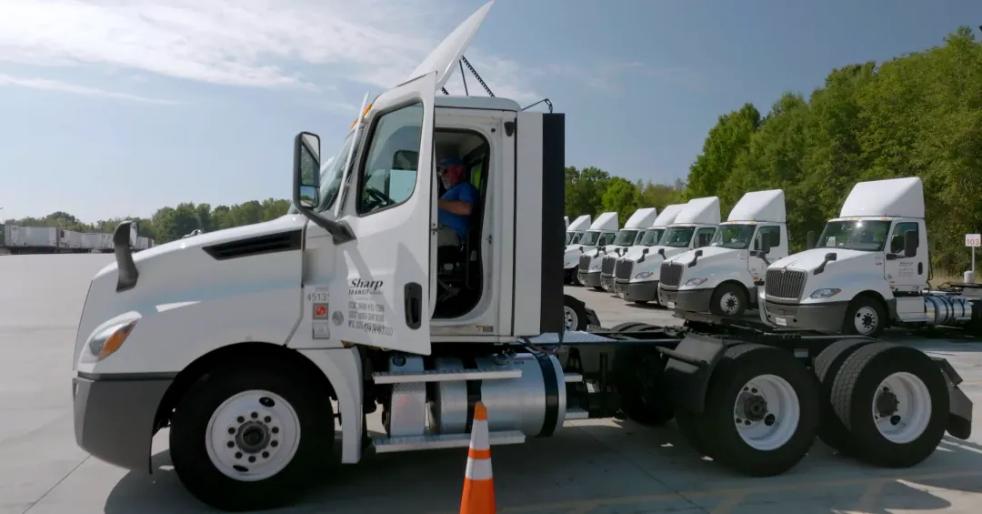Local Company Driver Chris Fowler gets down from his late-model Sharp Transit tractor